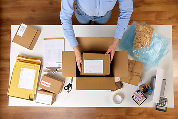 Image showing woman packing parcel boxes at post office