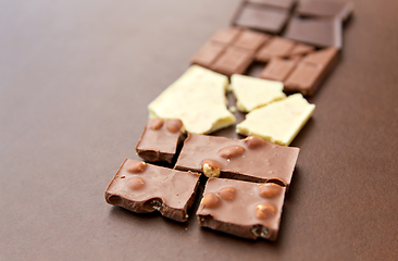 Image showing different kinds of chocolate on brown background