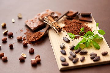 Image showing chocolate with nuts, cocoa beans and cinnamon