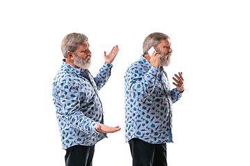 Image showing Senior man arguing with himself on white studio background.