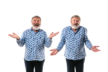 Image showing Senior man arguing with himself on white studio background.