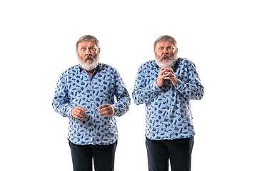 Image showing Senior man arguing with himself on white studio background.