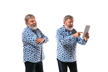 Image showing Senior man arguing with himself on white studio background.