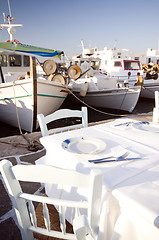 Image showing taverna setting in harbor with fishing boats