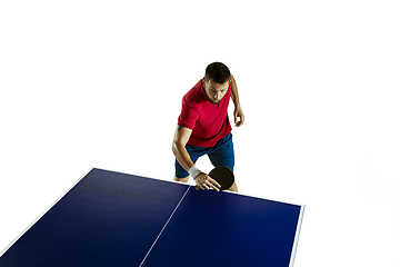 Image showing Young man playing table tennis on white studio background