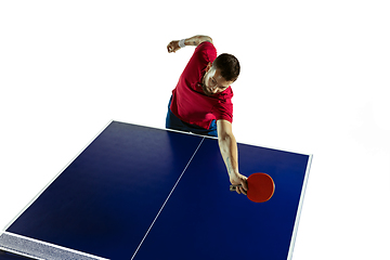 Image showing Young man playing table tennis on white studio background