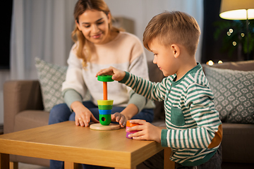 Image showing mother and son playing with toy pyramid at home