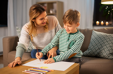 Image showing mother and son with pencils drawing at home