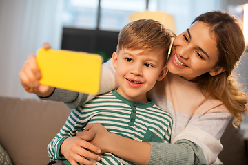 Image showing mother and son taking selfie by smartphone at home