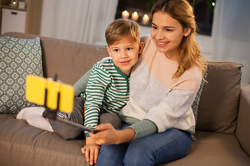 Image showing mother and son taking selfie by smartphone at home