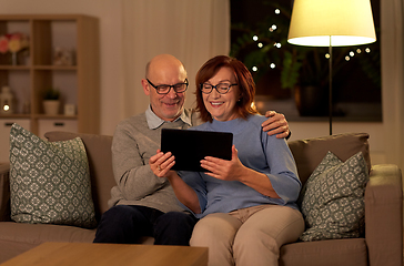 Image showing happy senior couple with tablet pc at home