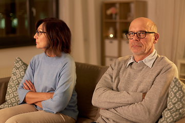 Image showing unhappy senior couple sitting on sofa at home