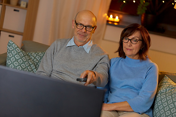 Image showing senior couple watching tv at home in evening