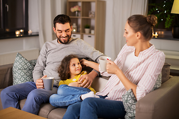 Image showing portrait of happy family sitting on sofa at home