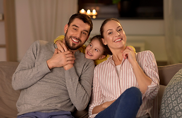 Image showing portrait of happy family sitting on sofa at home