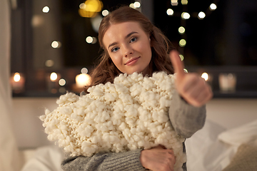 Image showing happy young woman with soft pillow in bed at home