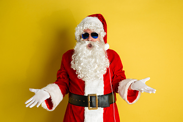 Image showing Santa Claus with modern eyeglasses isolated on yellow studio background