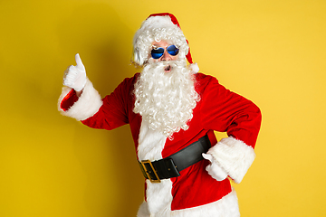 Image showing Santa Claus with modern eyeglasses isolated on yellow studio background