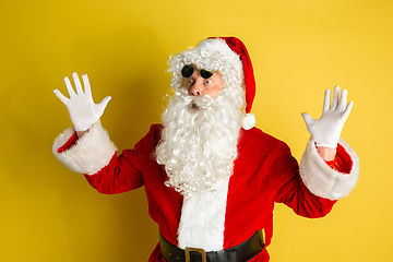 Image showing Santa Claus with modern eyeglasses isolated on yellow studio background