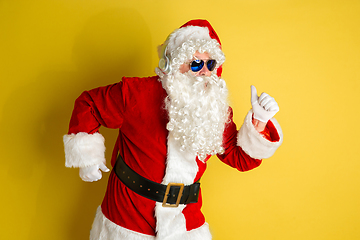 Image showing Santa Claus with modern eyeglasses isolated on yellow studio background