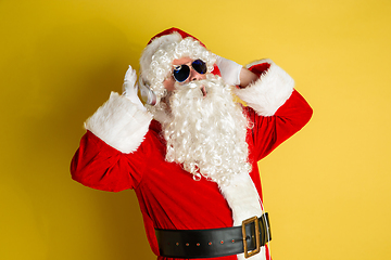 Image showing Santa Claus with modern eyeglasses isolated on yellow studio background