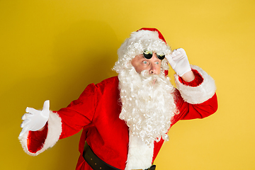 Image showing Santa Claus with modern eyeglasses isolated on yellow studio background