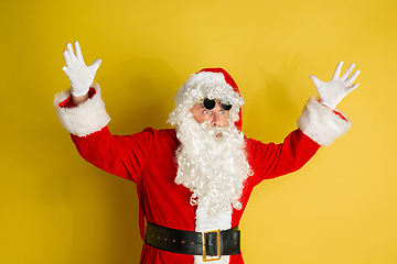 Image showing Santa Claus with modern eyeglasses isolated on yellow studio background