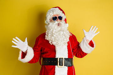 Image showing Santa Claus with modern eyeglasses isolated on yellow studio background