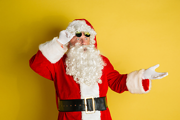 Image showing Santa Claus with modern eyeglasses isolated on yellow studio background