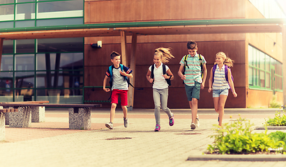 Image showing group of happy elementary school students running