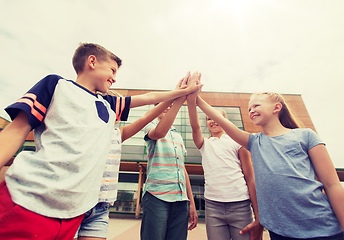 Image showing group of children making high five at school yard