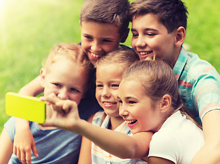 Image showing happy kids or friends taking selfie in summer park