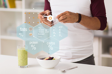 Image showing hands with phone and food nutritional value chart