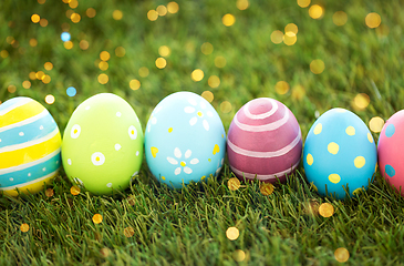 Image showing row of colored easter eggs on artificial grass