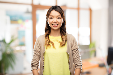 Image showing happy asian woman over office background