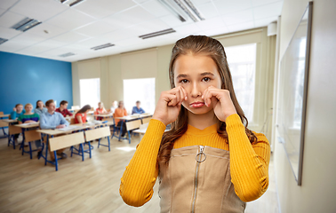 Image showing unhappy teenage student girl crying at school