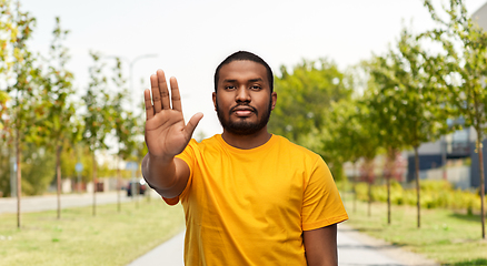 Image showing african american man showing stop gesture outdoors