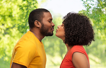 Image showing happy african american couple reaching for kiss