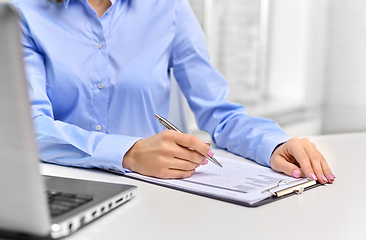 Image showing businesswoman with papers working at office