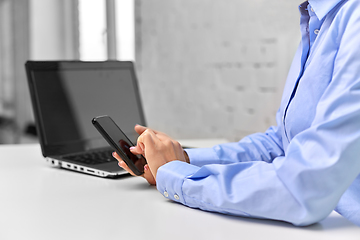 Image showing businesswoman with smartphone at office