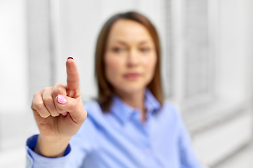 Image showing businesswoman touching something with finger