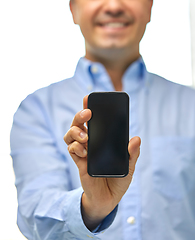 Image showing happy businessman showing smartphone screen