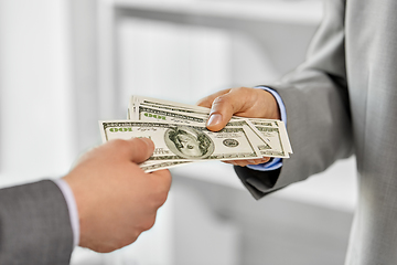 Image showing close up of businessmen's hands holding money