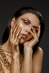 Image showing beautiful girl with many golden and bronze chains