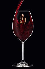 Image showing girl in red dress inside wine glass