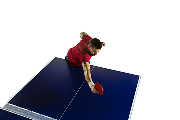 Image showing Young man playing table tennis on white studio background