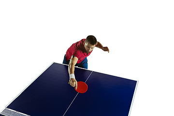 Image showing Young man playing table tennis on white studio background