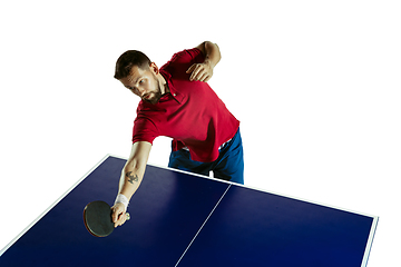 Image showing Young man playing table tennis on white studio background