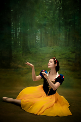 Image showing Young ballet dancer as a Snow White with poisoned apple in forest