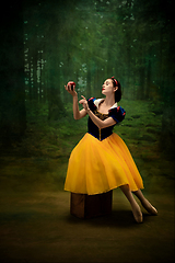 Image showing Young ballet dancer as a Snow White with poisoned apple in forest